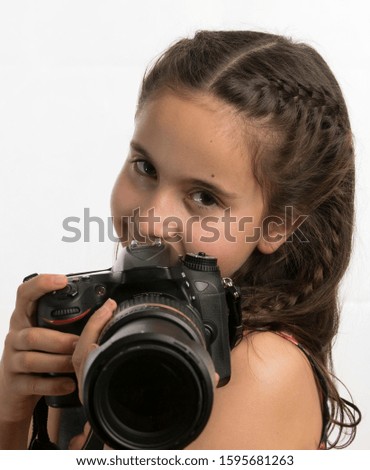 Girl looking a professional camera - isolated on white