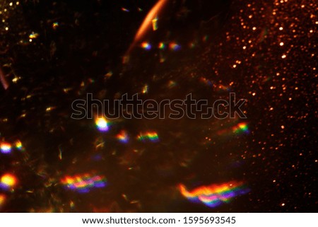 Easy to add lens flare effects for overlay designs or screen blending mode to make high-quality images. Abstract sun burst, digital flare, iridescent glare over black background. Defocused dark bokeh.