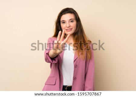 Young brunette girl with blazer over isolated background happy and counting three with fingers
