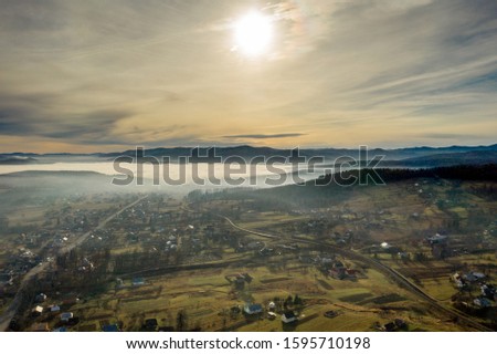 Image of beautiful village in the mountains, view of fog over little town, many houses in Lebanese mountain, gorgeous landscape, picturesque rural place, traveling and vacation concept.