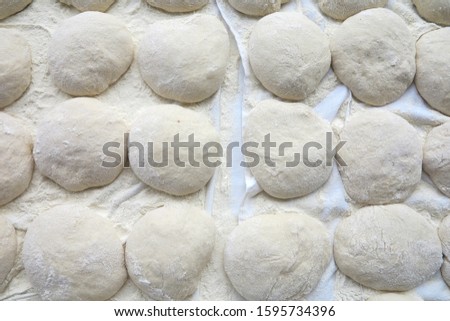 Bread dough balls with dusting of flour.