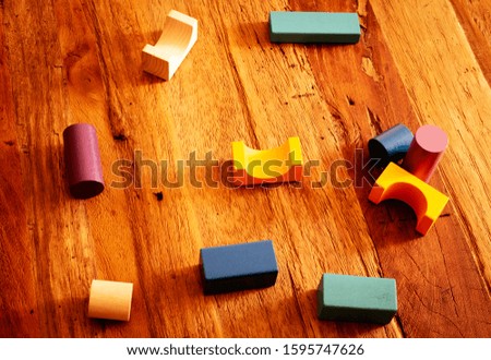 Toys blocks, multicolor wooden building bricks, heap of colorful game pieces on a wood table.
