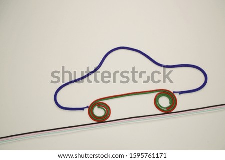 A car with colorful colored strings climbing a slope