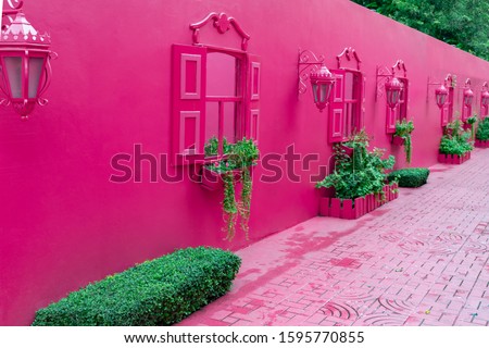Pink street with green plants, windows, street lams, decorative caribbean entourage in old city victorian style, Puerto plata, Dominican Republic. Royalty-Free Stock Photo #1595770855