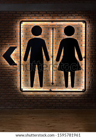 Labels for men and women,Logo of men and women bathroom on brick brown background,Sign of men and women bathroom on brick brown background.