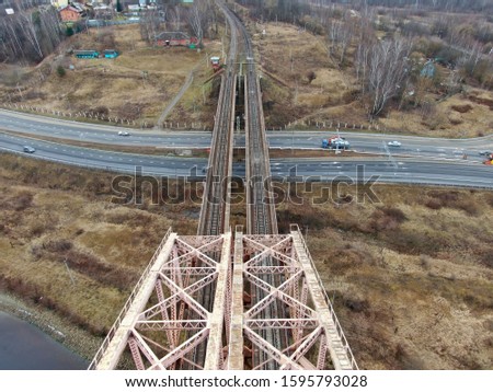 Aerial view panorama of railway bridge over river and high-speed road highway. the picture from the drone