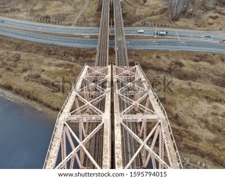 Aerial view panorama of railway bridge over river and high-speed road highway. the picture from the drone