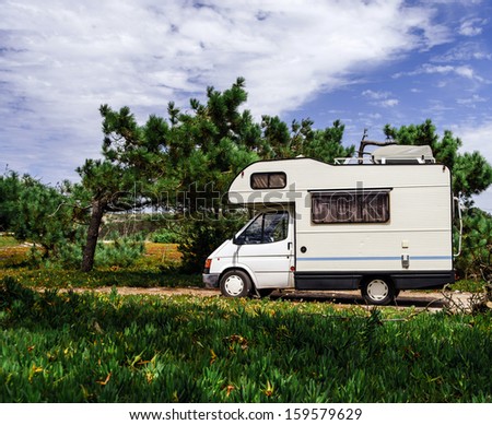 Touristic caravan staying in a forest. Comfort and freedom. Royalty-Free Stock Photo #159579629