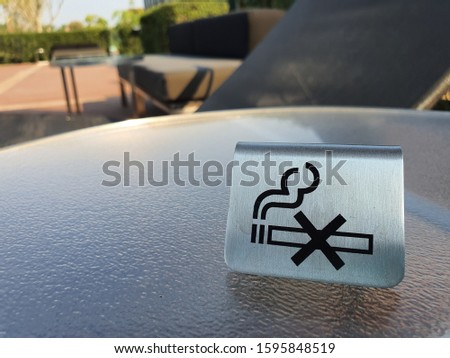 No smoking sign on table in public zone. Sign and symbol concept, 