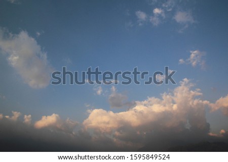 Beautiful sunrise sky with white fluffy clouds and light sunshine in early morning