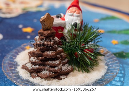 Stacked cocoa cookies christmas tree with colourful christmas background 