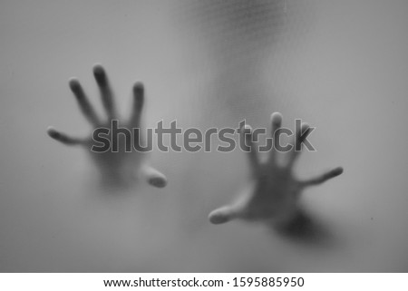Shadow behind the glass. Shadow hands of the Man behind frosted glass.Blurry hand abstraction. Black and white picture