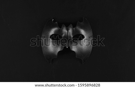 black abstract bat mask isolated on black background