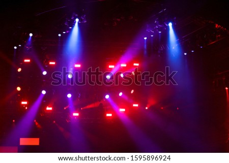 Purple light on a rock concert stage as background.
