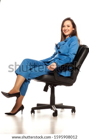 Young business woman seating on the chair on white background