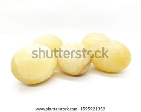Yellow marble eggs sued as decorations isolated on white background