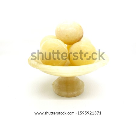 Yellow marble eggs sued as decorations isolated on white background