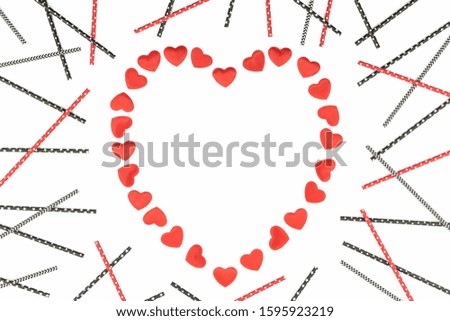 Small red fabric hearts frame monochrome isolated on white background with paper straws. 14 February. Passion, love and feelings St Valentine's Day Card celebration concept with copy space