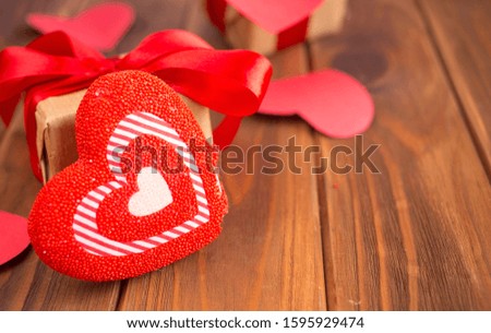 Red hearts and gifts on a wooden background. Valentine's Day Gift