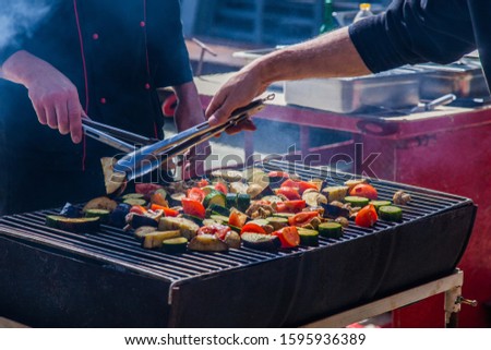 Chefs cook vegetables on the grill - zucchini, potatoes, mushrooms, eggplant Royalty-Free Stock Photo #1595936389
