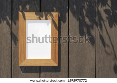 Wooden photo frame on wooden background