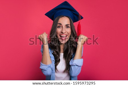 University is over. Close-up photo of a cute student in a blouse and a square academic hat, who is overjoyed, and screams with happiness for her success.