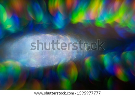 lens flare with wide aperture at f 1.1, colorful abstract, bokeh light on black background, real lens flare shot in studio, flash leak beam, optical effect of spotlight, cool retro photo overlay.