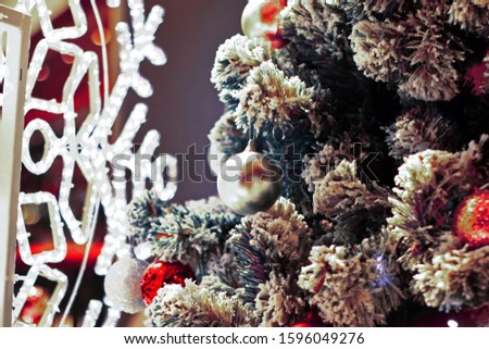 Decorations on a Christmas tree on blurred background.