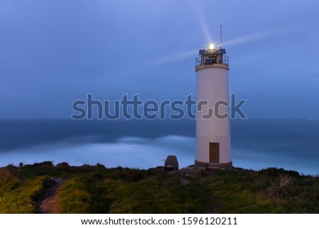 The small lighthouse north of the Spanish city of Laxe in Galicia on the Atlantic Ocean during high waves. The photo was taken in the night with 20 minutes exposure time with no wind.