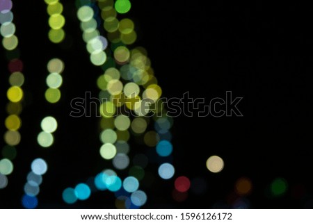 Golden abstract yellow, orange bokeh lights isolated on black background with copy space. Holiday and Christmas season concept, graphic resources, greeting card. wallpaper. Multi-colored lights