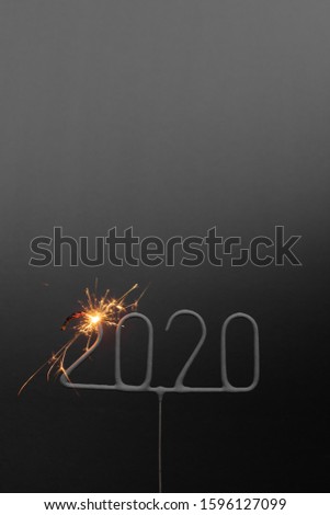 Sparkler shaped like the number 2020, just lit to celebrate the new year