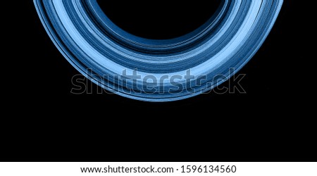 Macro photo of bright wavy paper tapes on isolated black background. Abstract modern background in trendy blue color. Color of the year 2020 concept. Futuristic concept.