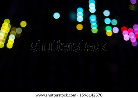 Golden abstract yellow, orange bokeh lights isolated on black background with copy space. Holiday and Christmas season concept, graphic resources, greeting card. wallpaper. Multi-colored lights