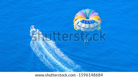 People parasailing with colorful parachute - Alanya, Antalya Royalty-Free Stock Photo #1596148684