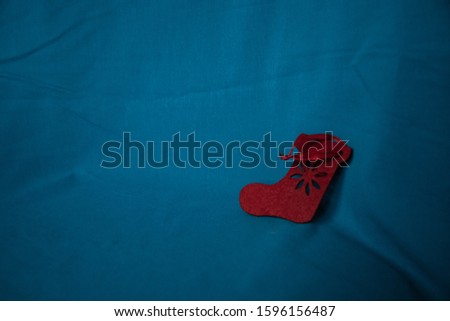 Red boot on a blue background. Toy for christmas and new year.