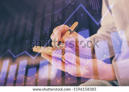 Double exposure hands with stock market chart.