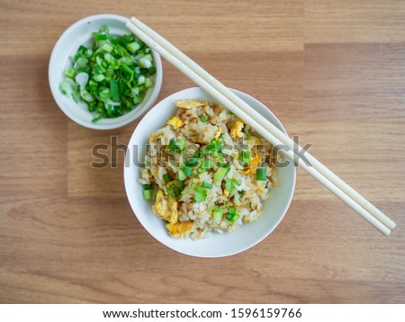 Fried rice with chicken ingredient Rice Egg Soy sauce Sugar Pepper Spring onion Food in Asian,Background wood