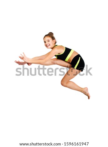 Flexible cute little girl child gymnast jumping and having fun isolated on a white background. Sport, training, fitness, active lifestyle concept