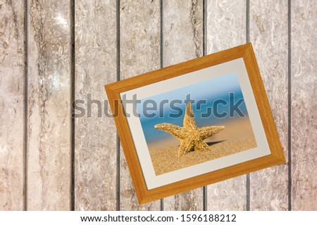 Picture holiday starfish in sand on desk background