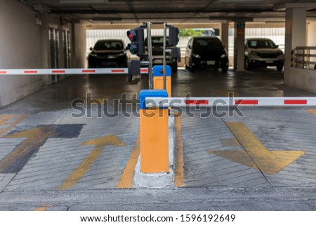Car park automatic entry system.Security system for building access - barrier gate stop with toll booth, traffic cones.
