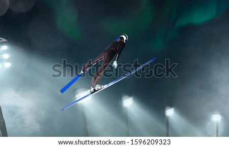 Skier on ski jumping competitiont on evening. Winter sport.