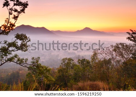 
Beautiful scenery of fog at sunrise behind mountains. The sun and morning fog on the hill in Thailand. Beautiful tourist attractions in Loei Province, Thailand.