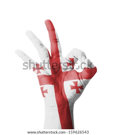Hand making Ok sign, Georgia flag painted as symbol of best quality, positivity and success - isolated on white background