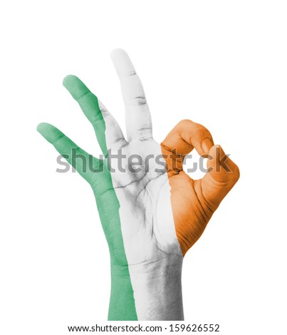 Hand making Ok sign, Ireland flag painted as symbol of best quality, positivity and success - isolated on white background