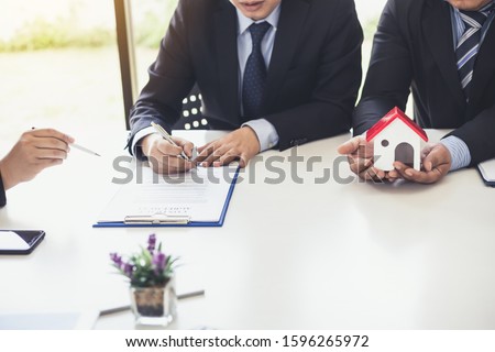 Businessman signing of investment and real estate contract.