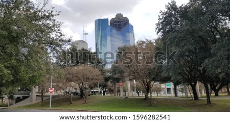 downtown Houston behind green trees