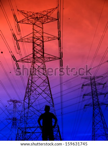 Silhouette man standing in front of electricity pylon background