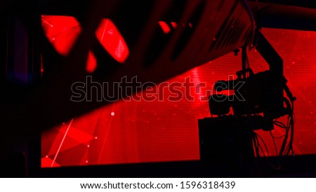 professional studio camera in front of colorful backdrop, focus on camera
