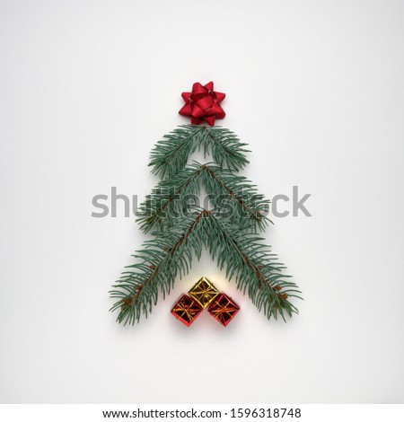 Stylized Christmas tree made of fir branches with gift boxes on white background. View from above, flat lay