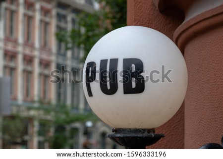 PUB written on a white sphere light cover